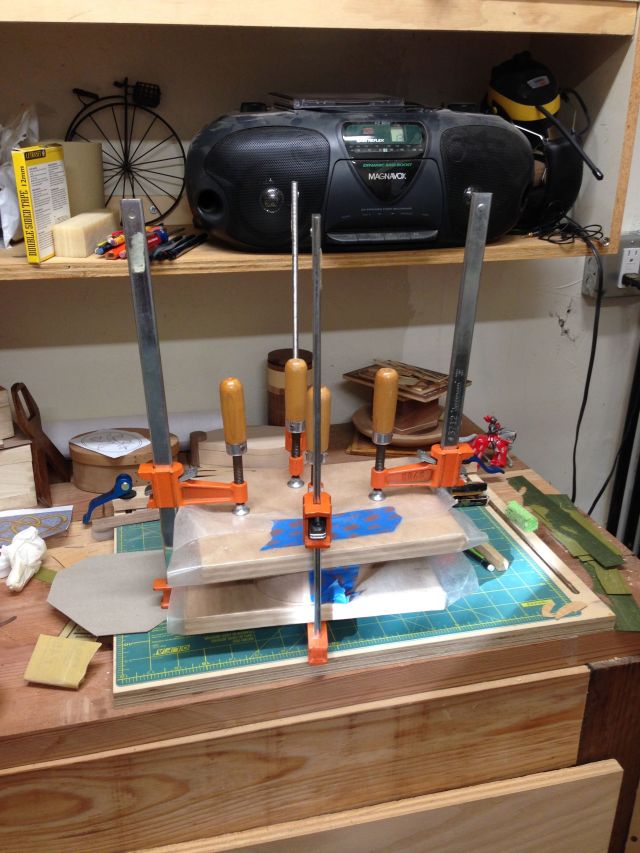 The box in clamps during the gluing process.