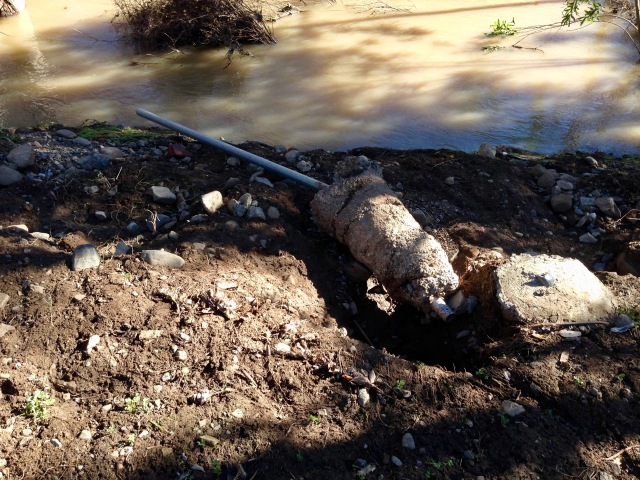 The flood took out about 20 feet of chainlink fence.  This post was just lifted out of the ground.